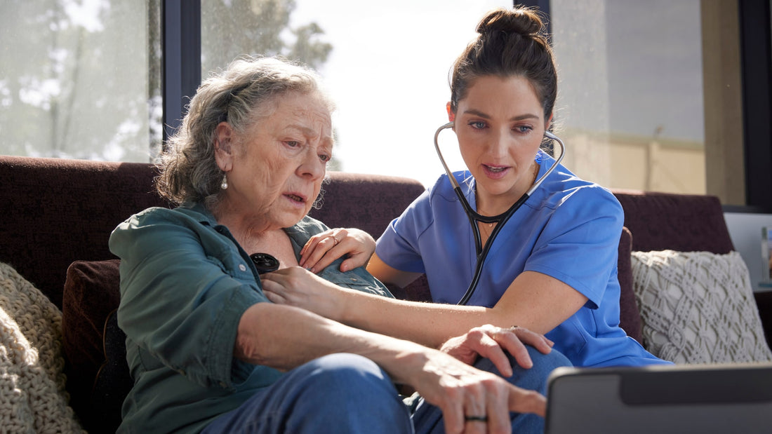 Clinician listens to elderly woman's heart with digital stethoscope